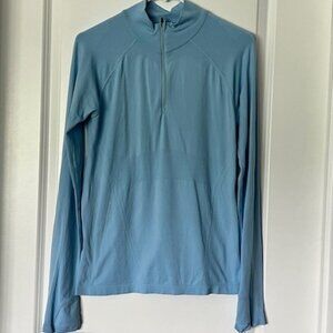 Athleta ladies light blue pullover, 1/2 zip with mock neck, thumb holes. Sz Med